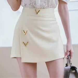 Soft white mini skirt skort short with V-shaped metal snaps Medium